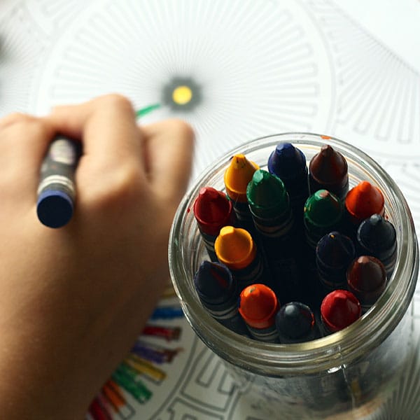 Child drawing with crayons