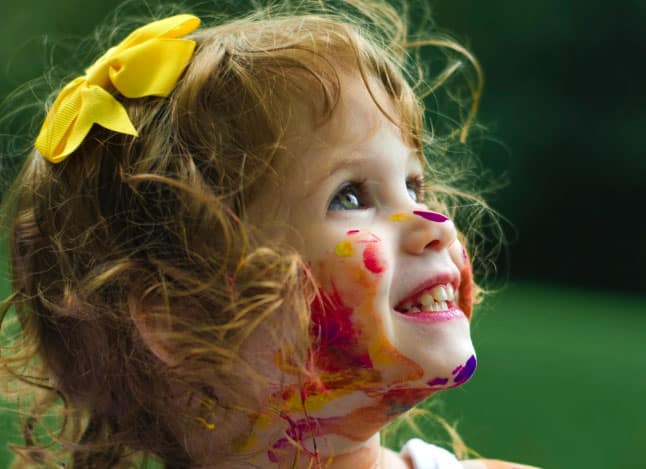 Smiling girl with paint on her face